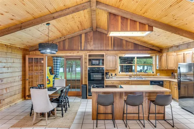 a view of a patio with a table and chairs and potted plants