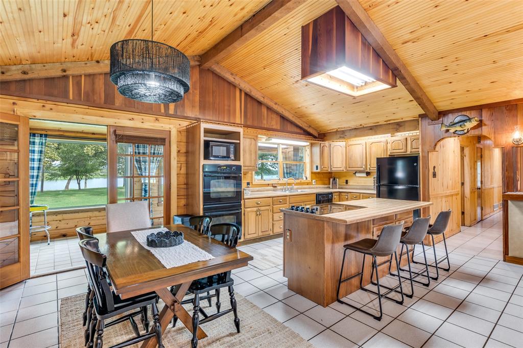 779 County Road 1971 Yantis, TX 75497 - Photo 13 of 40 a view of a dining table and chairs in the patio