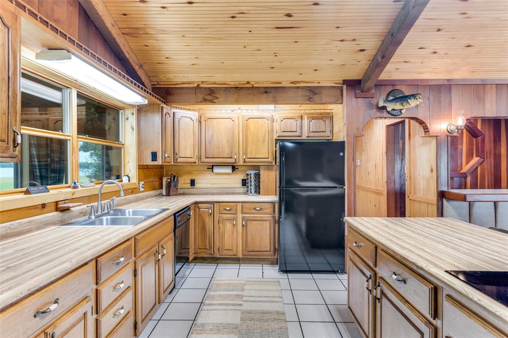 779 County Road 1971 Yantis, TX 75497 - Photo 16 of 40 a kitchen with a sink refrigerator and cabinets