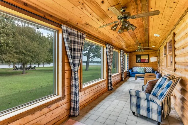 a view of a porch with furniture and garden