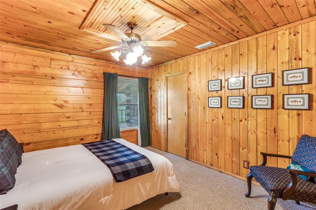 779 County Road 1971 Yantis, TX 75497 - Photo 24 of 40 a bedroom with a bed and a chair