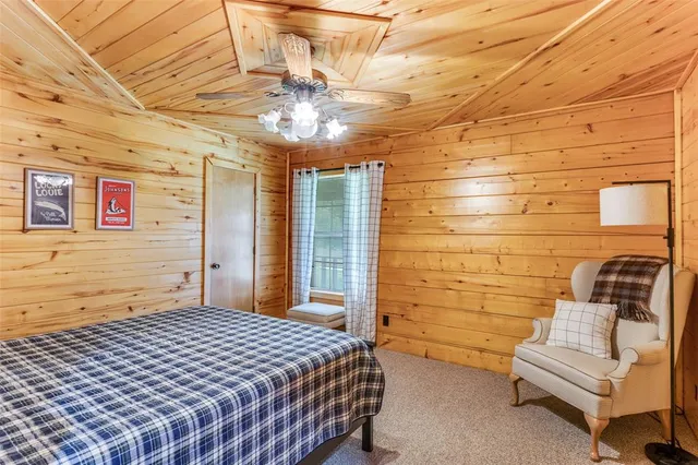 a bedroom with a bed and ceiling fan