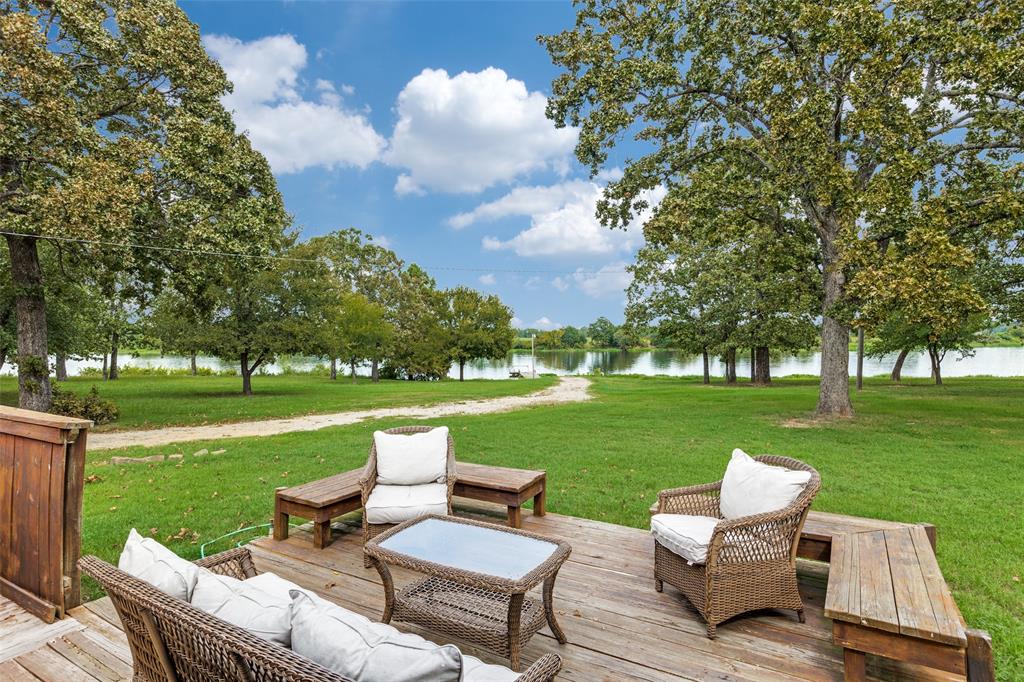 779 County Road 1971 Yantis, TX 75497 - Photo 31 of 40 a view of a patio with couches chairs and a big yard