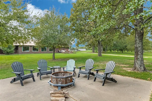 a view of a chairs and table in backyard of the house