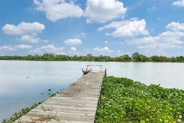 a view of a lake with houses in the back