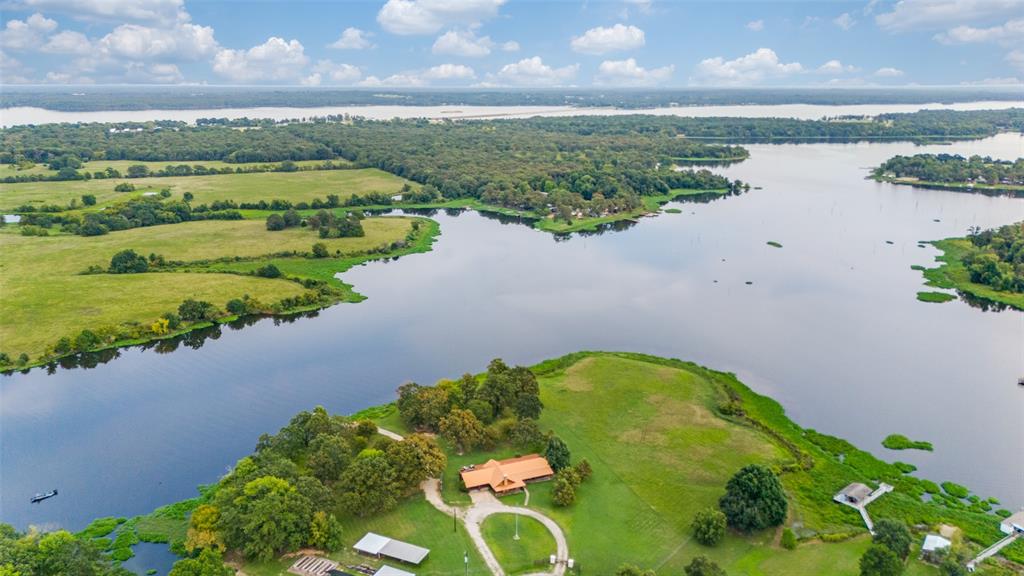 779 County Road 1971 Yantis, TX 75497 - Photo 5 of 40 a view of a lake with a garden