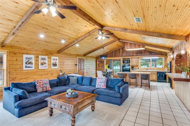 a living room with furniture a rug and white walls