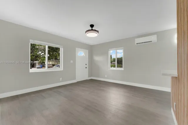 an empty room with windows and closet