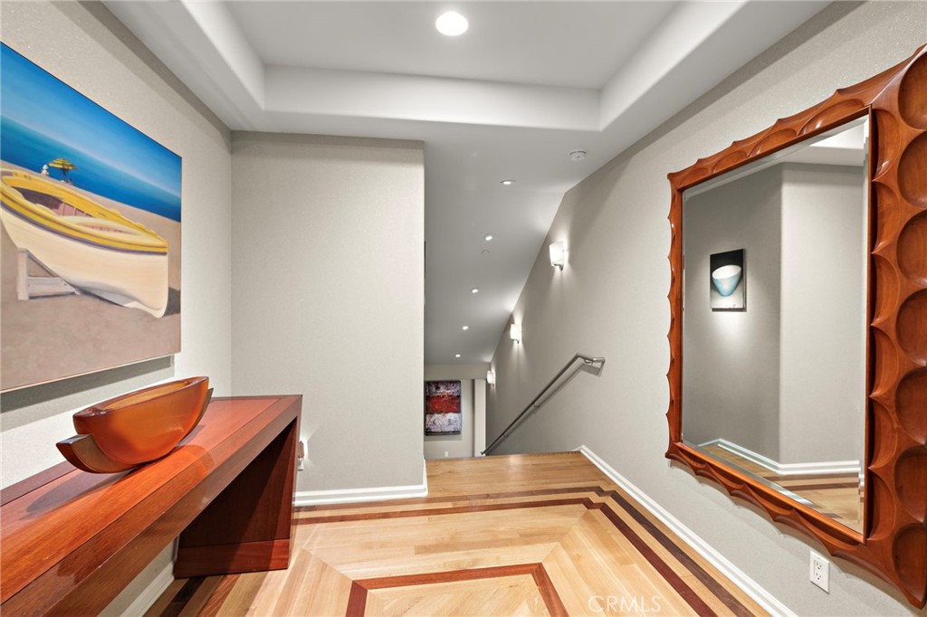 1603-1613 South Coast Highway, Unit F Laguna Beach, CA 92651 - Photo 4 of 38 Enter into the foyer with gorgeous wood flooring and art lighting leading you down the stairs.