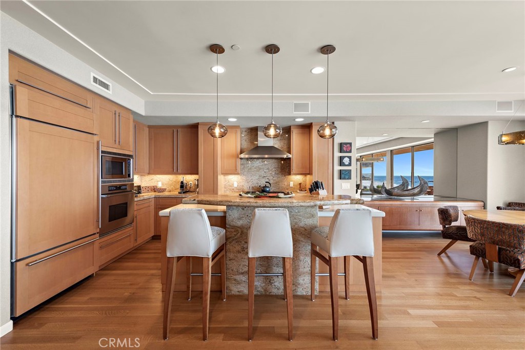 1603-1613 South Coast Highway, Unit F Laguna Beach, CA 92651 - Photo 6 of 38 Gourmet kitchen complete with high end stainless appliance package including 6 burner gas range, granite counters with island and breakfast bar, and bar with sub-zero wine fridge.