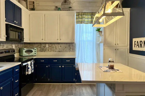 a kitchen with stainless steel appliances granite countertop a sink stove and cabinets