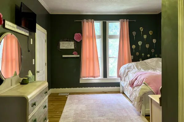 a bedroom with a bed and a chandelier