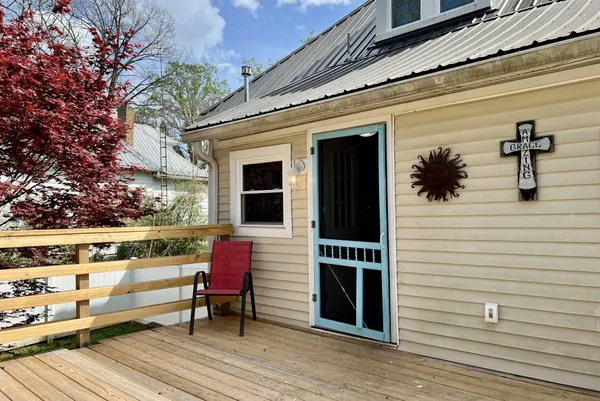 a view of a deck with trees in the background
