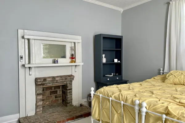 a bedroom with a bed and a fireplace