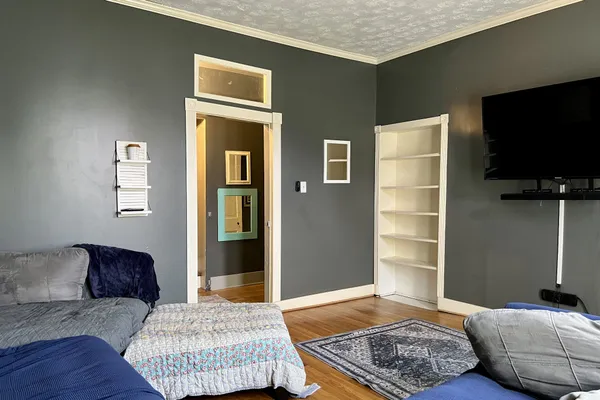 a living room with furniture and a flat screen tv