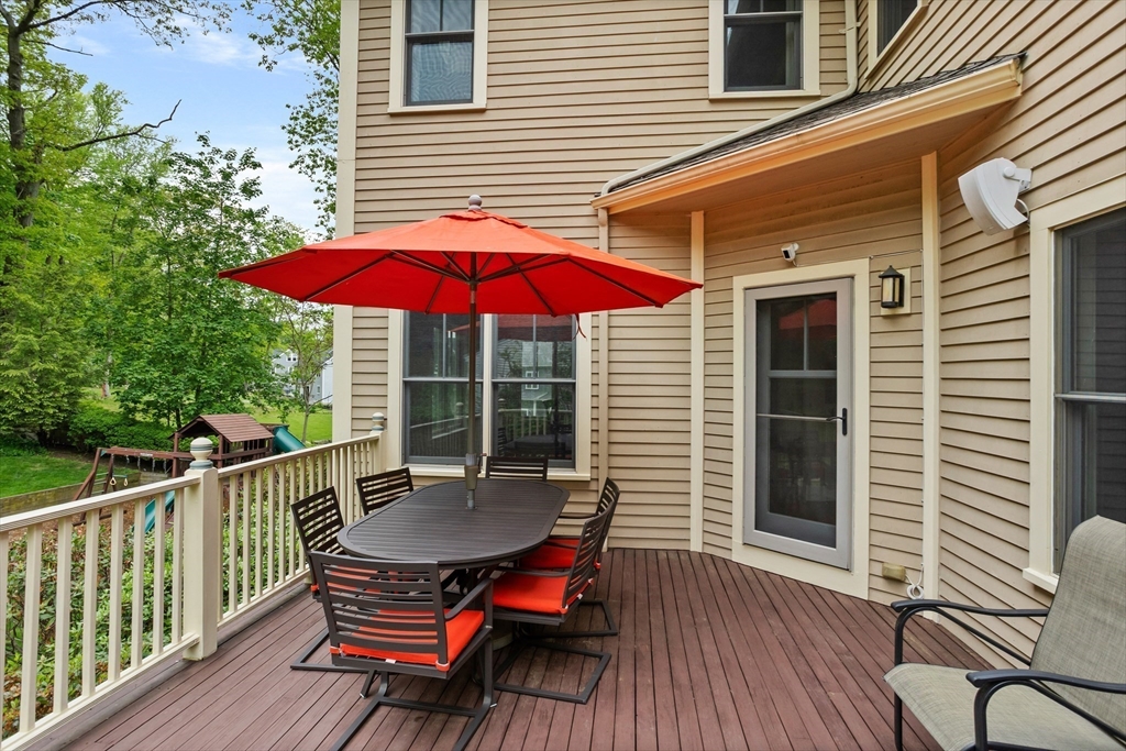 5 Walnut Street Lexington, MA 02421 - Photo 25 of 34 a view of a wooden deck with furniture