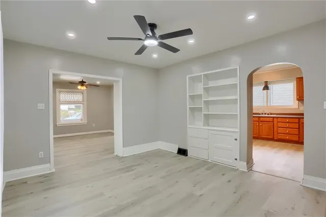 an empty room with closet and wooden cabinet