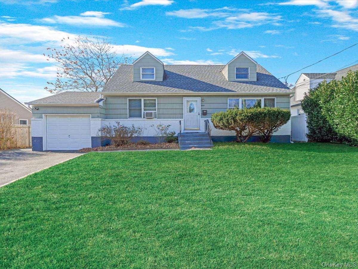 Cape cod home featuring driveway, roof with shingles, and a garage