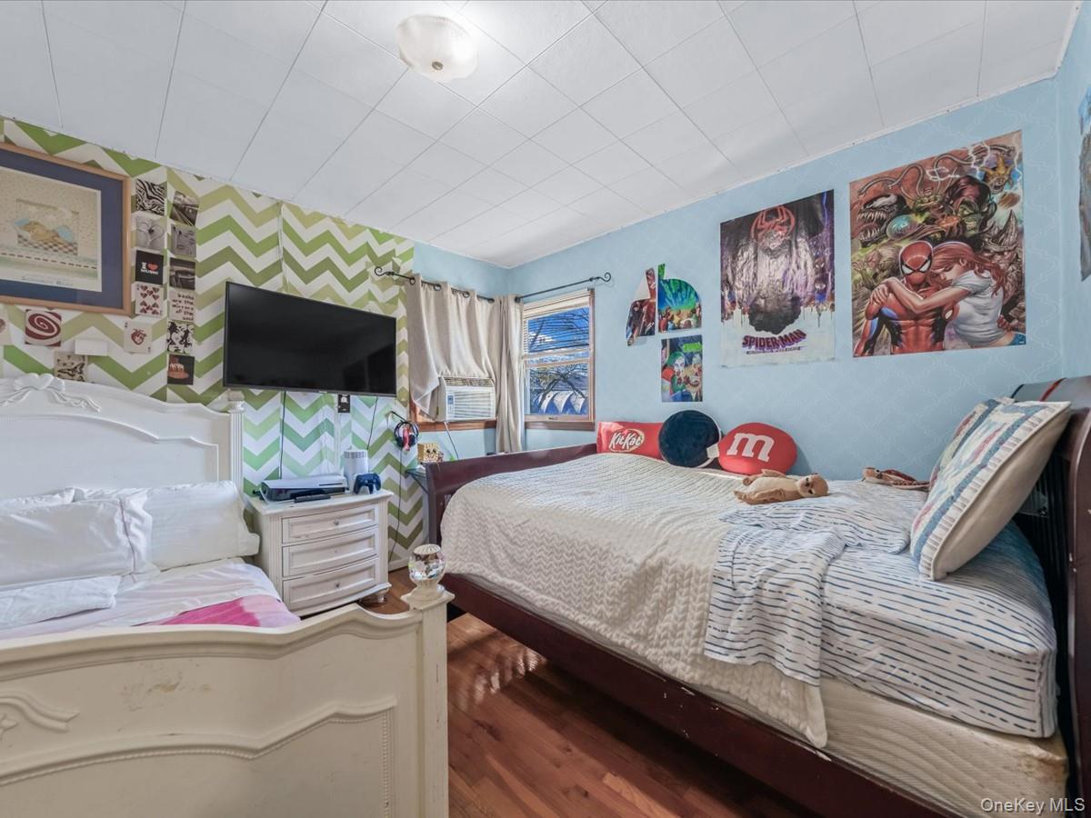 205 Lenox Road Huntington Station, NY 11746 - Photo 11 of 25 Bedroom with wallpapered walls and wood finished floors