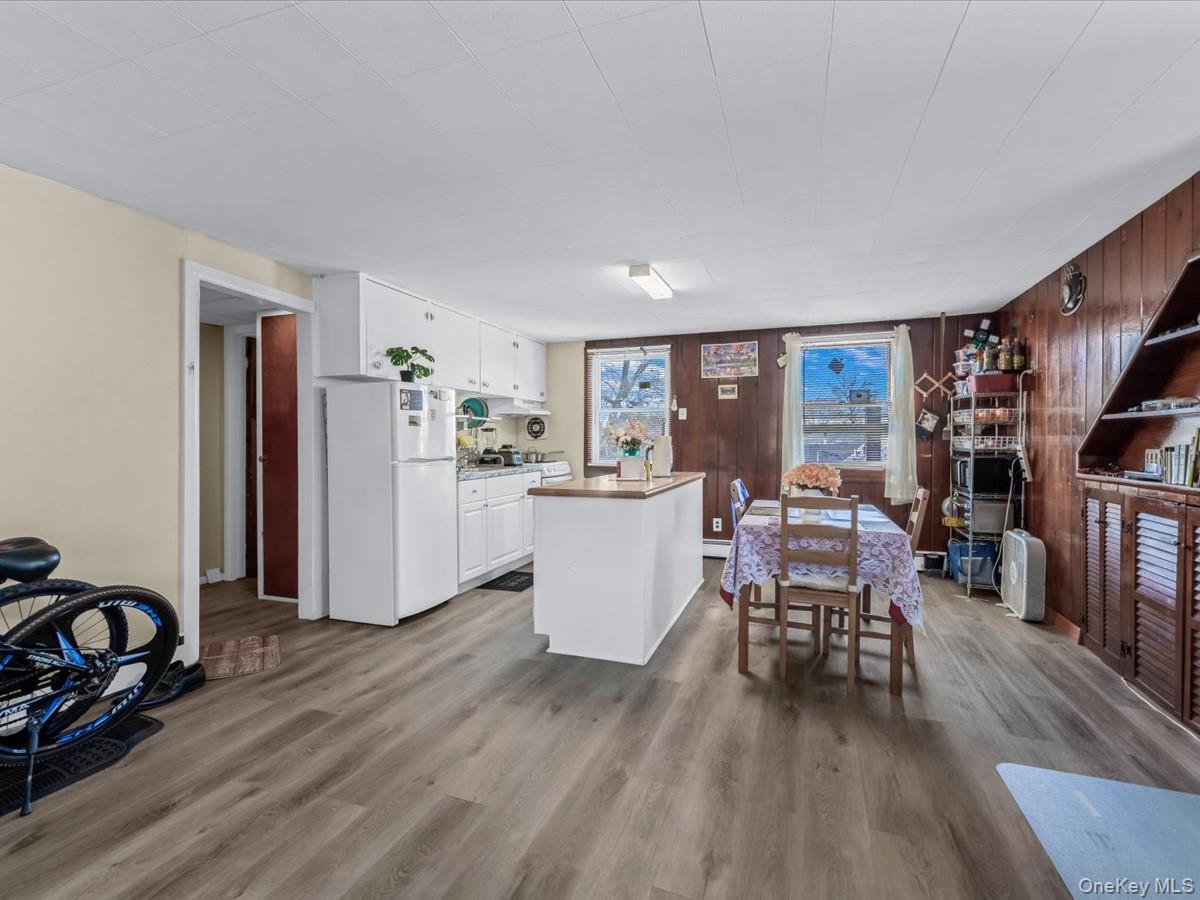 205 Lenox Road Huntington Station, NY 11746 - Photo 14 of 25 Dining room featuring wooden walls and wood finished floors