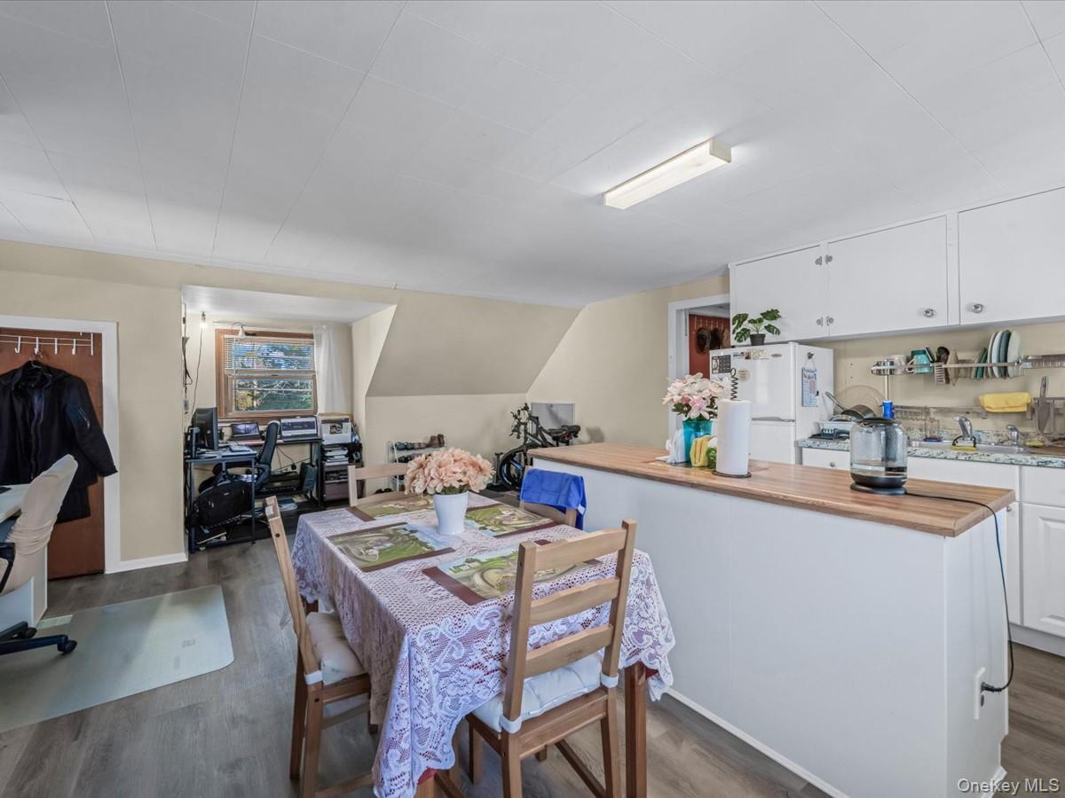 205 Lenox Road Huntington Station, NY 11746 - Photo 17 of 25 Dining space with dark wood-type flooring, a desk, and lofted ceiling