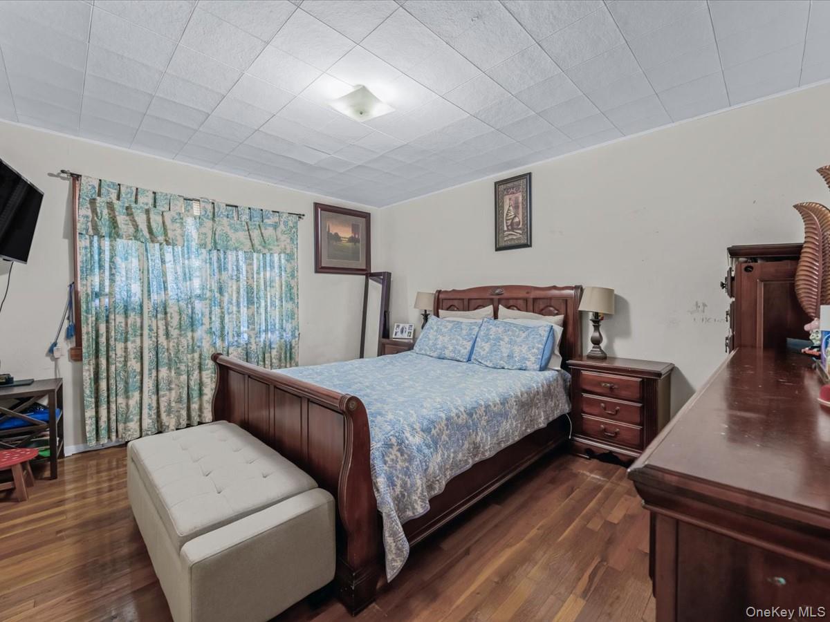 205 Lenox Road Huntington Station, NY 11746 - Photo 9 of 25 Bedroom featuring dark wood finished floors