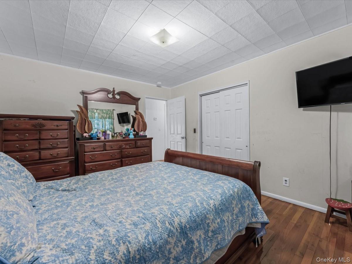 205 Lenox Road Huntington Station, NY 11746 - Photo 10 of 25 Bedroom featuring dark wood-style flooring and a closet