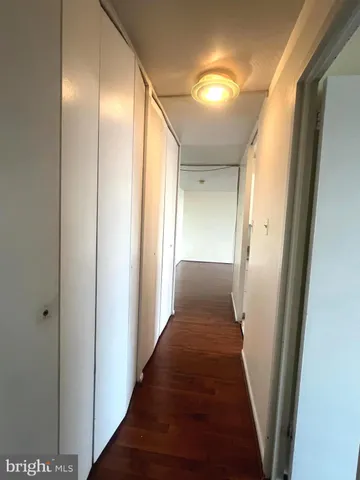 a view of a hallway with wooden floor