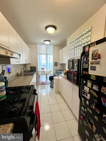 a kitchen with stainless steel appliances a stove a sink and cabinets