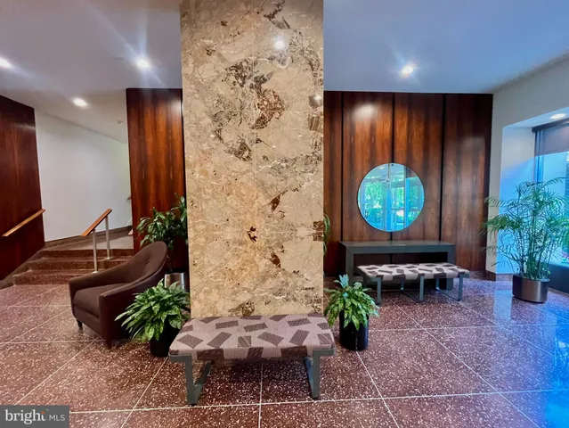 a view of a lobby with chair and flowers