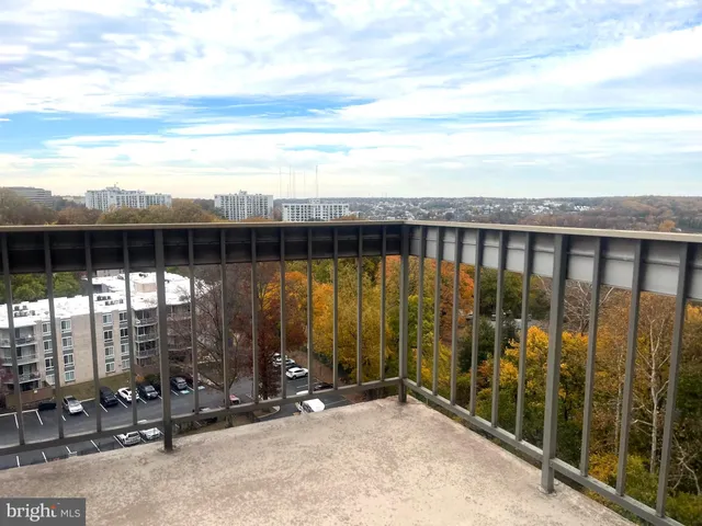 a view of a terrace with lawn chairs