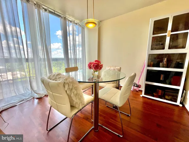 a dining room with furniture and wooden floor