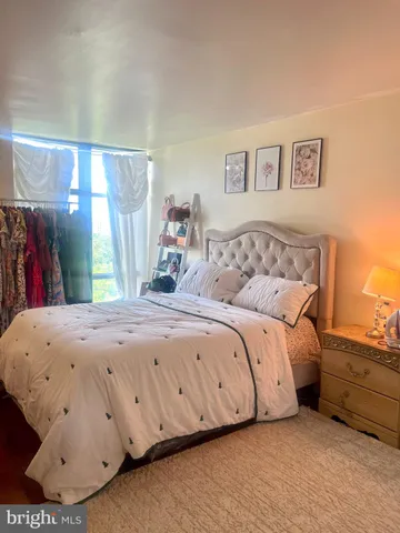 a bedroom with a bed and a window