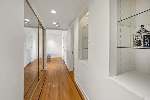 a view of a hallway with wooden floor