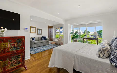 a bed room with a bed window and a television