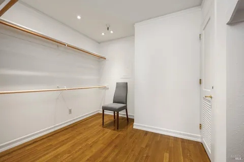 a view of a room with wooden floor and bench