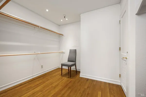 a view of a room with wooden floor and bench