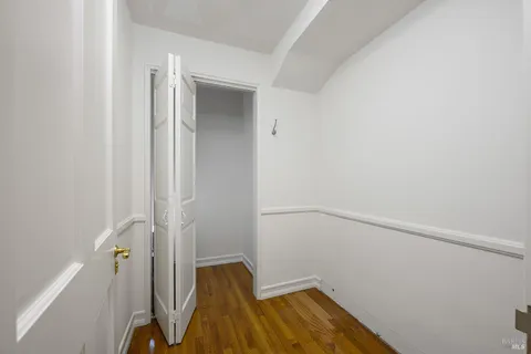 a view of a room with wooden floor