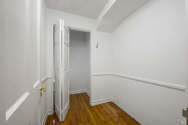 a view of a room with wooden floor