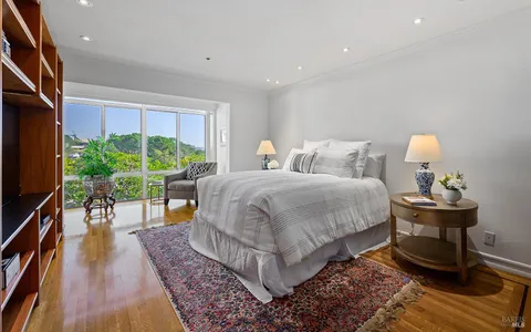 a spacious bedroom with a bed and a potted plant