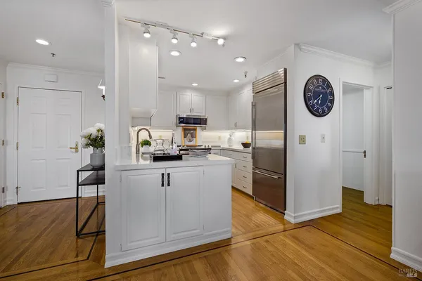 a kitchen with stainless steel appliances granite countertop a refrigerator and a stove