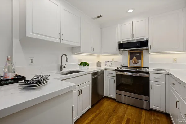 a kitchen with a sink stove and cabinets