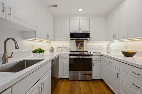 a kitchen with a sink and appliances