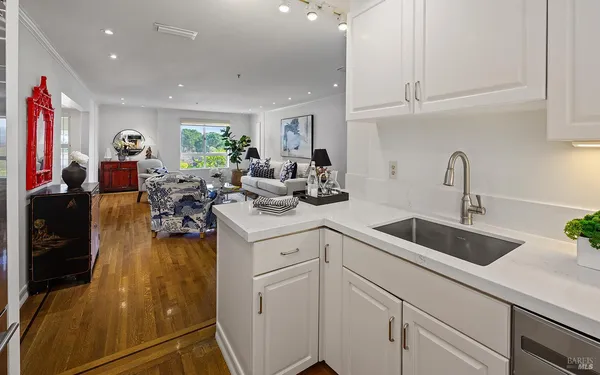 a kitchen with sink refrigerator and cabinets