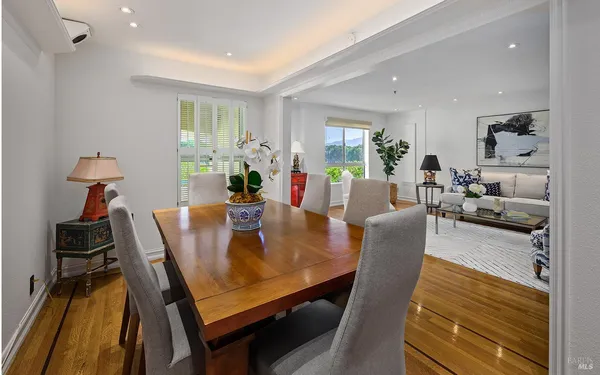 a view of a dining room with furniture and wooden floor