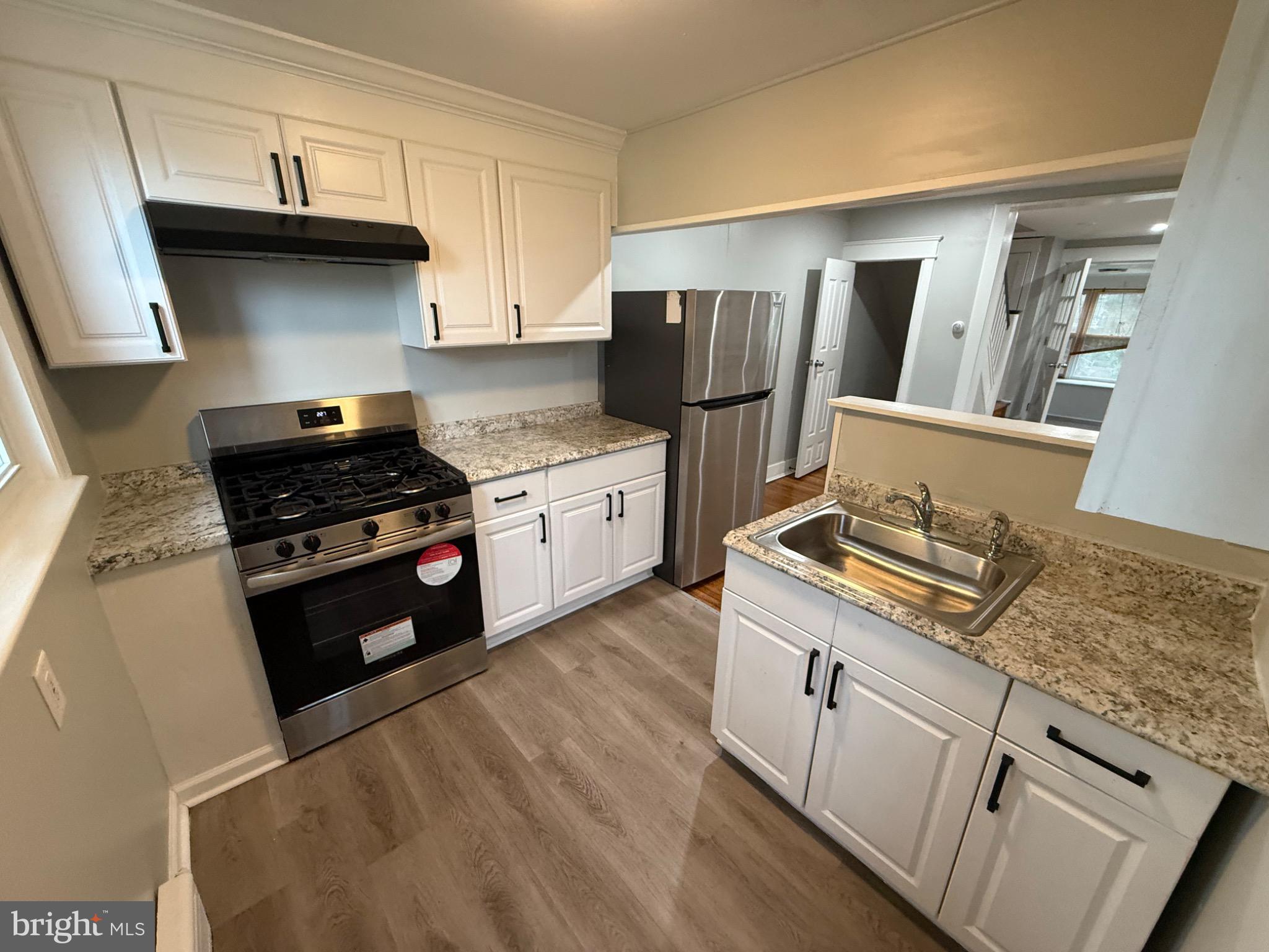 7249 Guilford Road Upper Darby, PA 19082 - Photo 5 of 19 a kitchen with granite countertop a stove sink and refrigerator