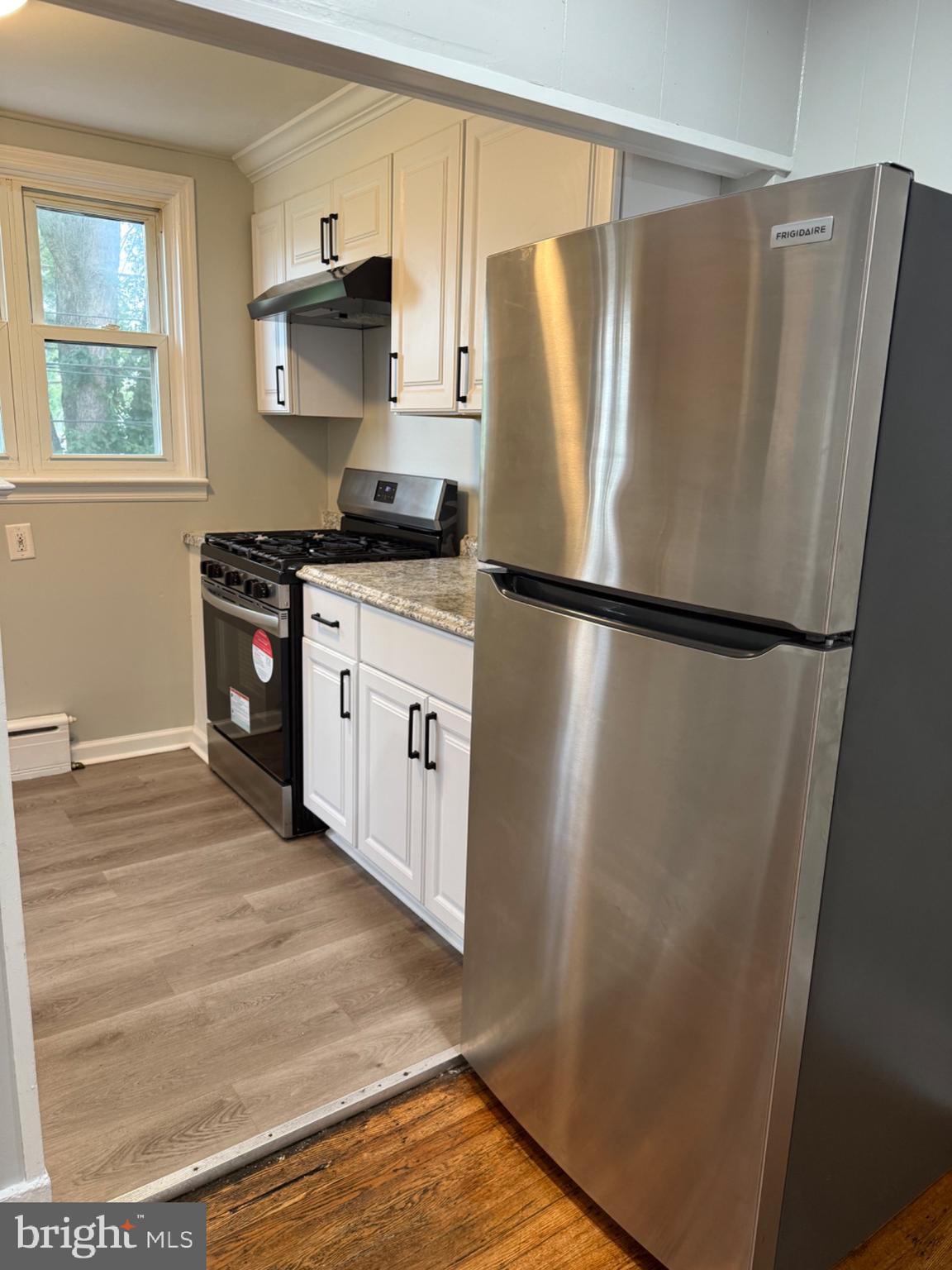 7249 Guilford Road Upper Darby, PA 19082 - Photo 6 of 19 a kitchen with stainless steel appliances a refrigerator and a stove top oven