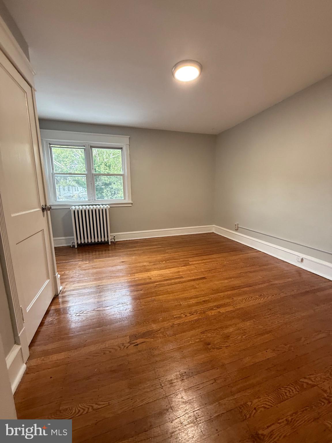 7249 Guilford Road Upper Darby, PA 19082 - Photo 7 of 19 an empty room with wooden floor and windows