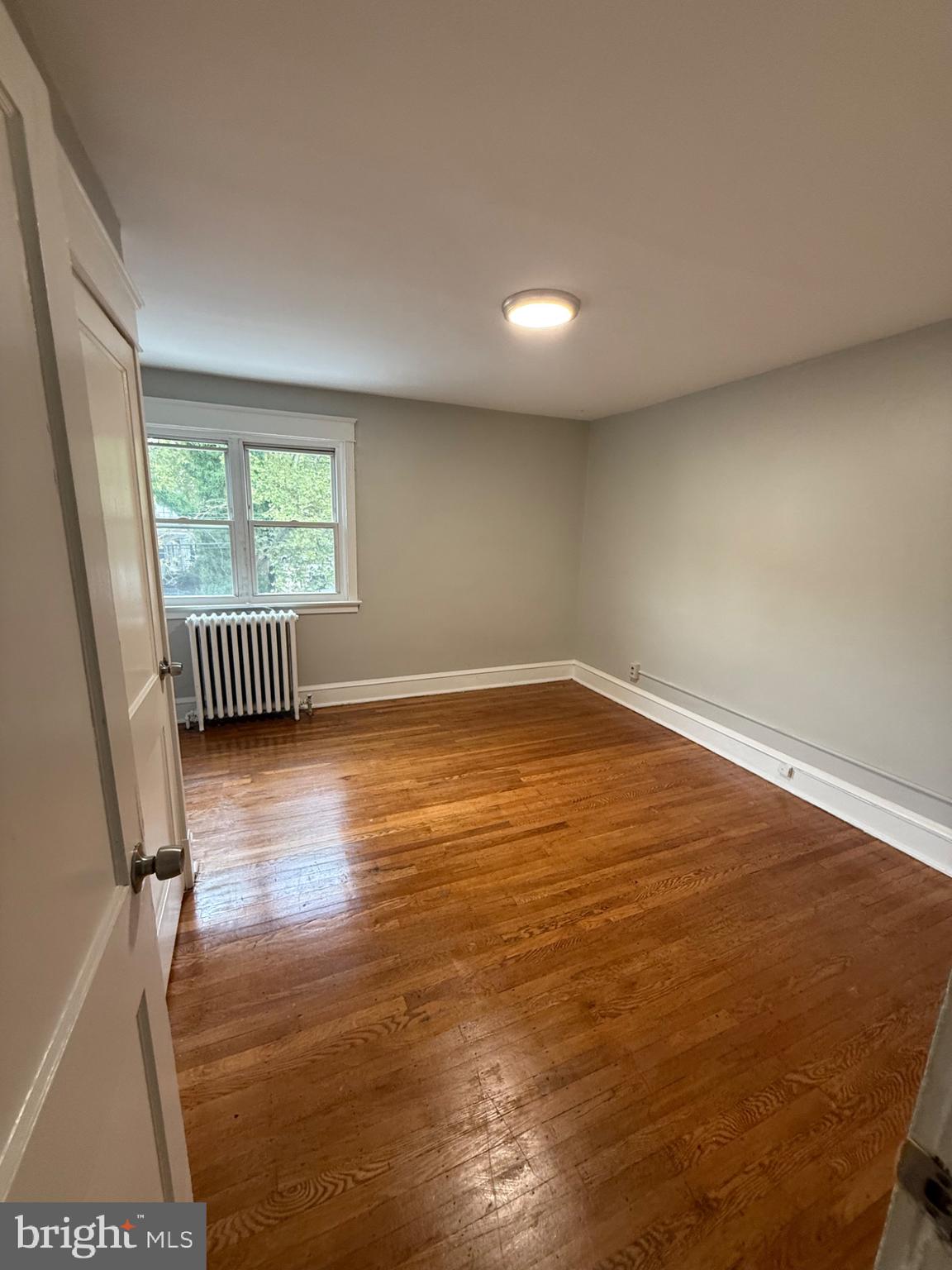 7249 Guilford Road Upper Darby, PA 19082 - Photo 9 of 19 an empty room with wooden floor and windows