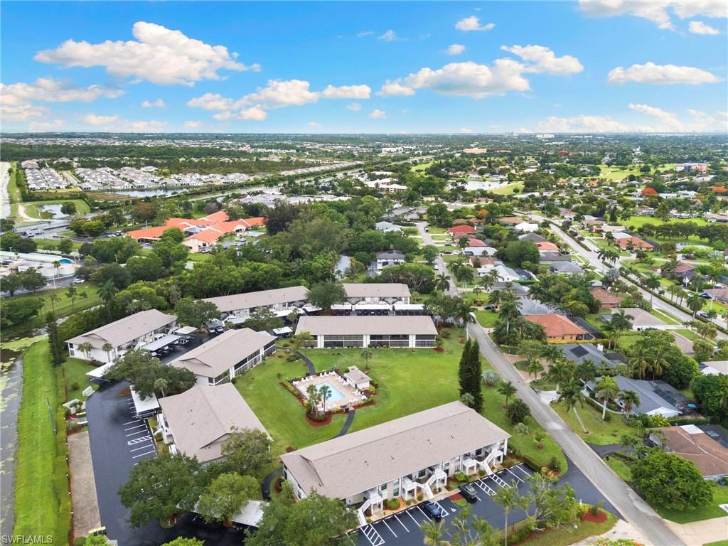 236 Pebble Beach Circle, Unit A202 Naples, FL 34113 - Photo 24 of 25 an aerial view of a house with a lake view